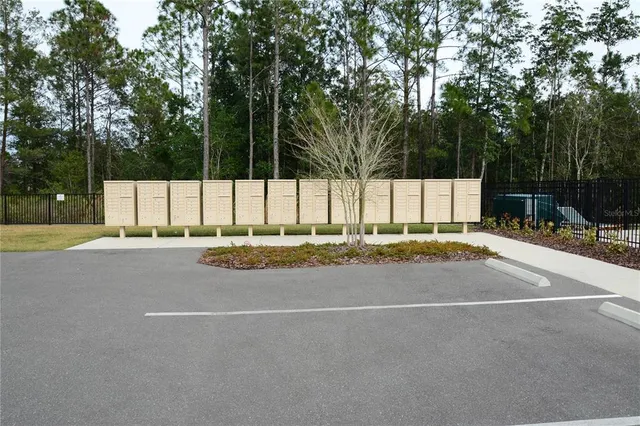 a view of a house with a small yard and plants