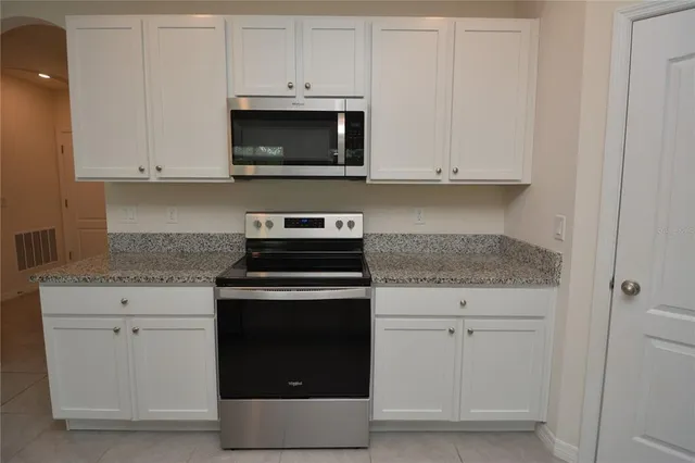 a kitchen with appliances and cabinets