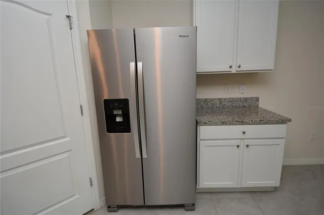 a view of a kitchen with a sink and refrigerator