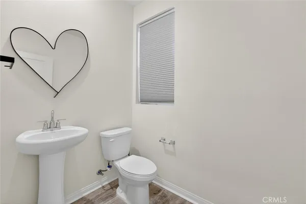 a bathroom with a sink toilet and a mirror