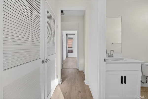 a view of a house with a small yard plants and large tree