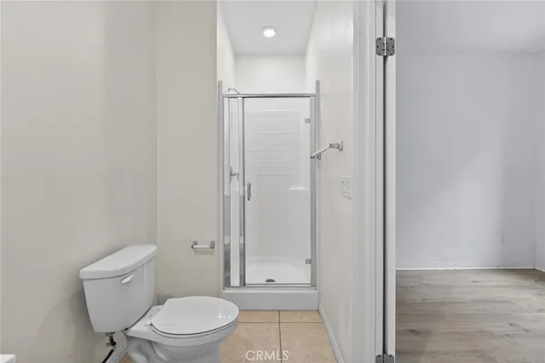 a bathroom with a toilet a sink and shower