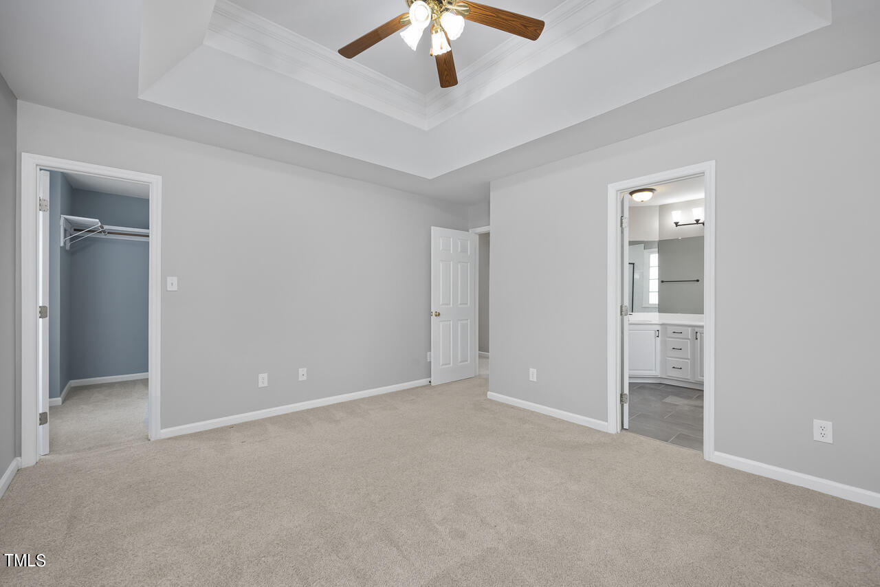 6921 Lamarsh Court Raleigh, NC 27617 - Photo 17 of 37 an empty room with chandelier fan