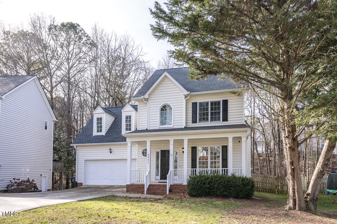6921 Lamarsh Court Raleigh, NC 27617 - Photo 2 of 37 a view of a white house with a large pool and a tree