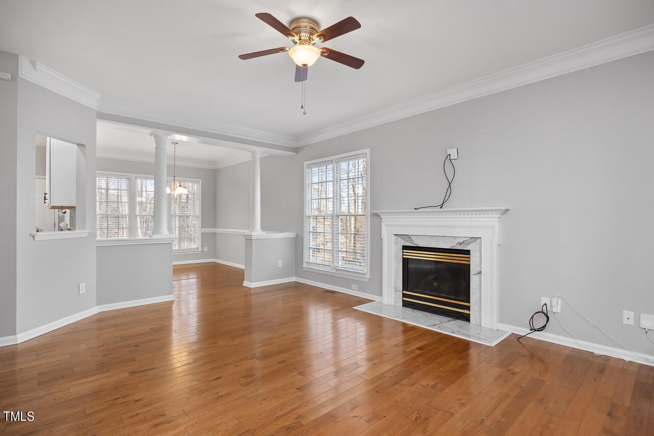 6921 Lamarsh Court Raleigh, NC 27617 - Photo 5 of 37 a view of empty room with wooden floor and fireplace