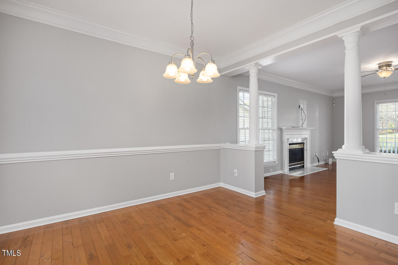 6921 Lamarsh Court Raleigh, NC 27617 - Photo 7 of 37 a view of a livingroom with wooden floor and a kitchen