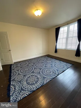 a view of a closet with wooden floor