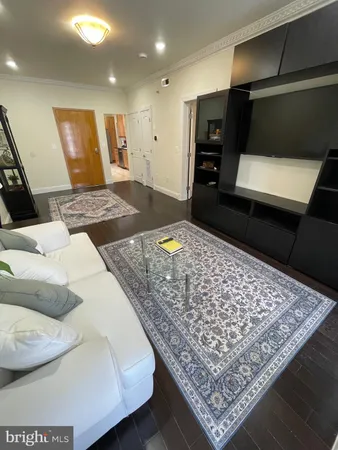 a living room with a couch and a rug