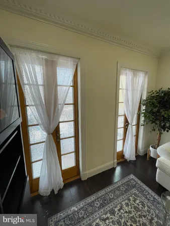 a view of entryway with wooden floor and stairs