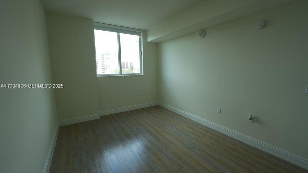 987 Southwest 37th Avenue, Unit 1205 Miami, FL 33135 - Photo 5 of 8 an empty room with a window