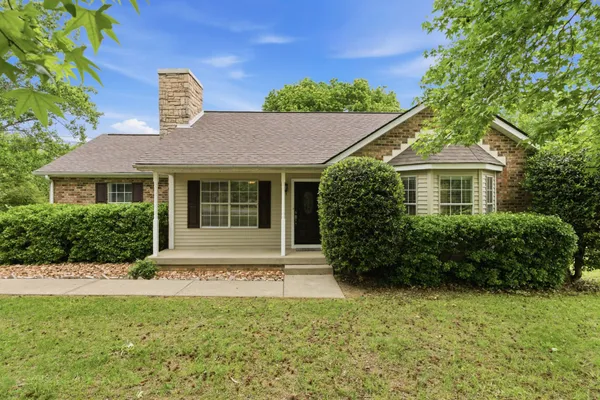 a front view of a house with a garden