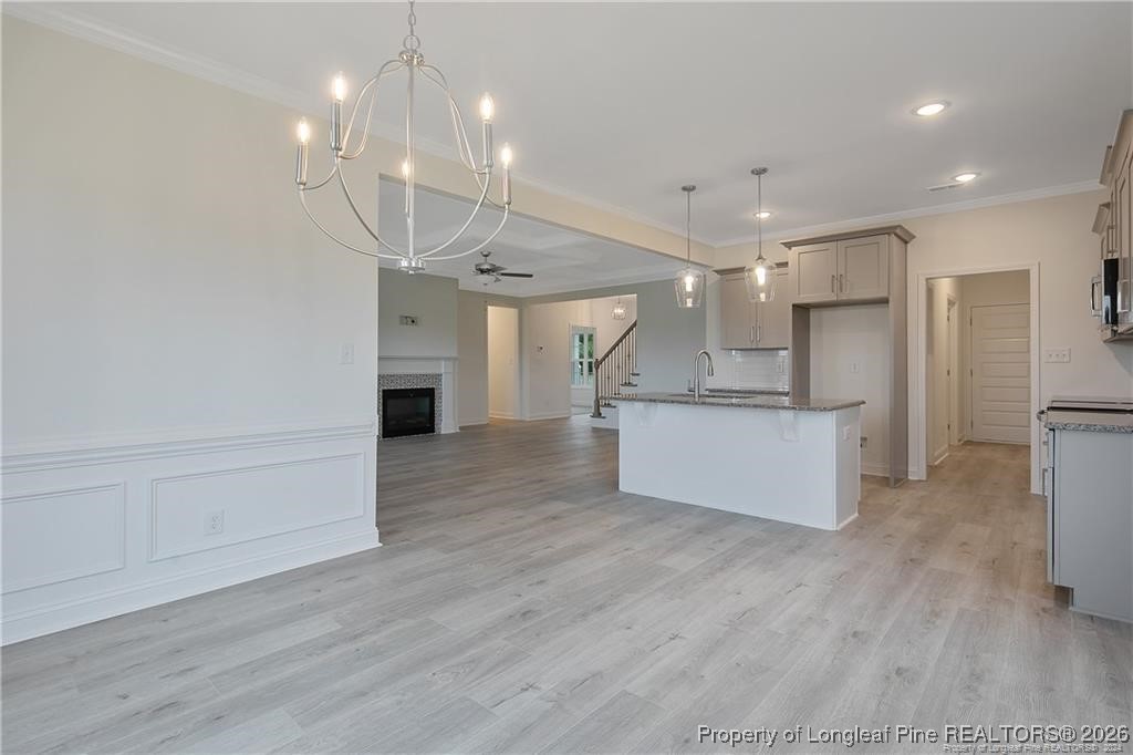 6732 Sim Canady Road Hope Mills, NC 28348 - Photo 2 of 5 a view of a big room with wooden floor kitchen and a window