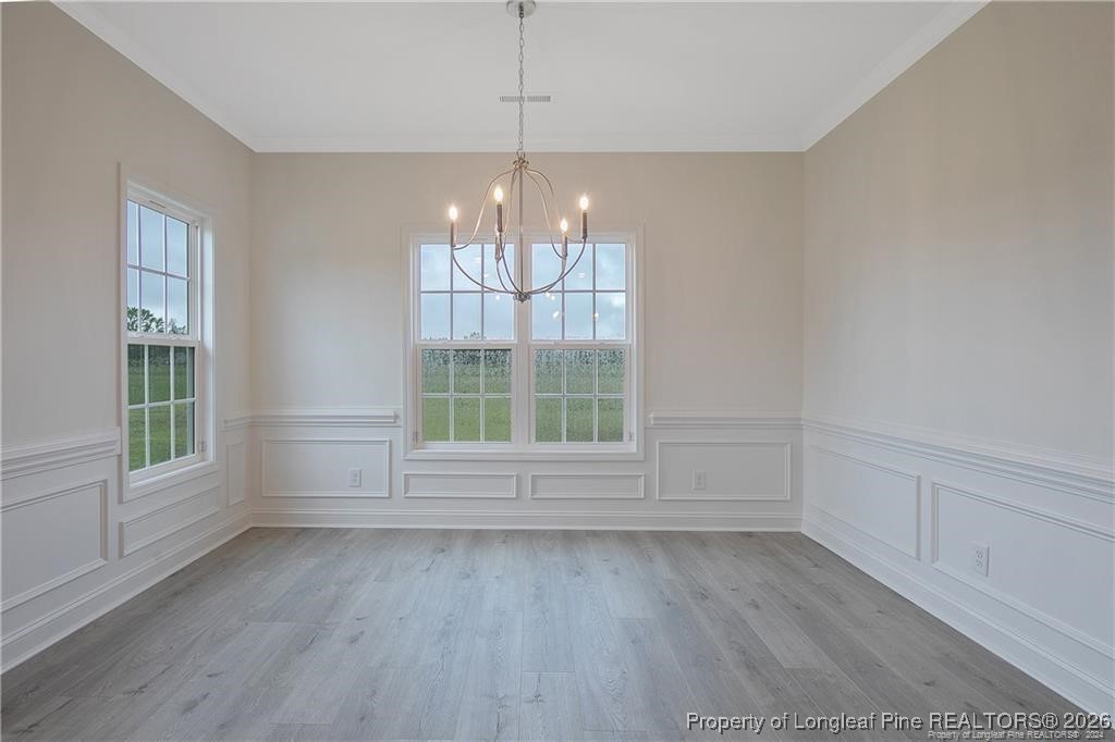 6732 Sim Canady Road Hope Mills, NC 28348 - Photo 3 of 5 an empty room with wooden floor and windows