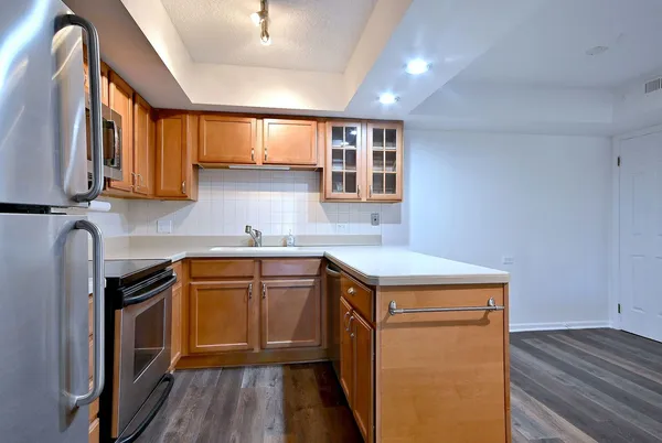 a kitchen with stainless steel appliances granite countertop a sink stove and cabinets