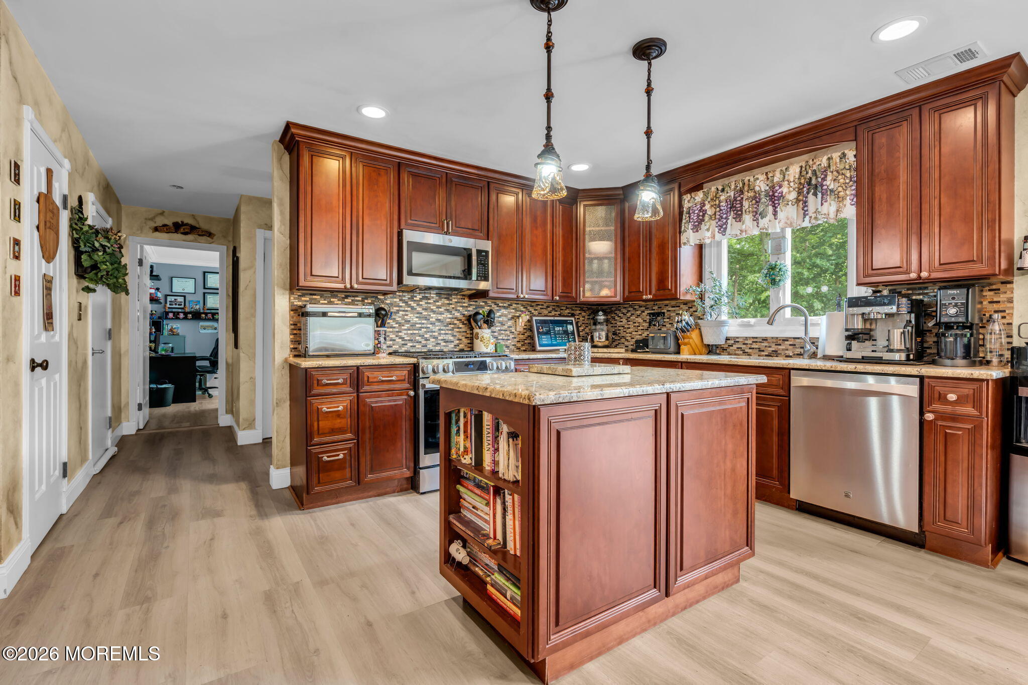 21 Ryan Road Marlboro, NJ 07746 - Photo 10 of 56 a kitchen with stainless steel appliances granite countertop a stove a sink dishwasher a refrigerator and a dining table with wooden floor