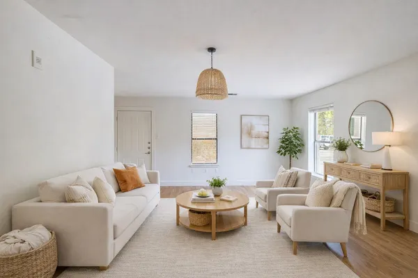 a living room with furniture and a clock
