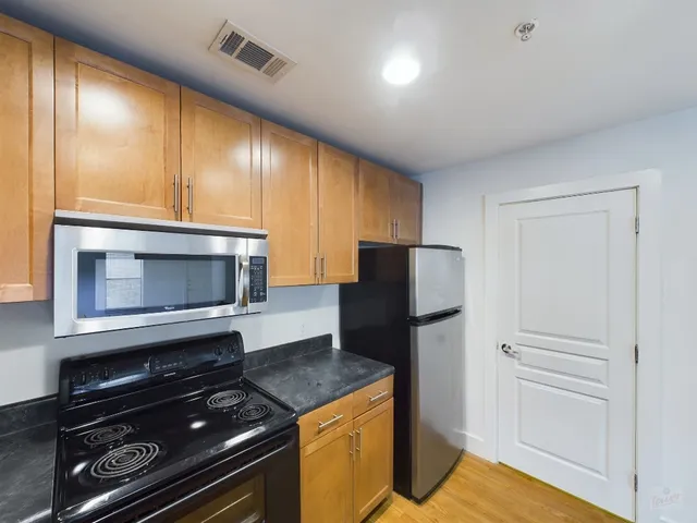 a kitchen with a refrigerator stove and microwave