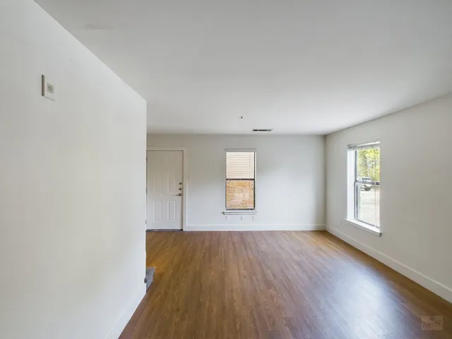a view of an entryway with wooden floor