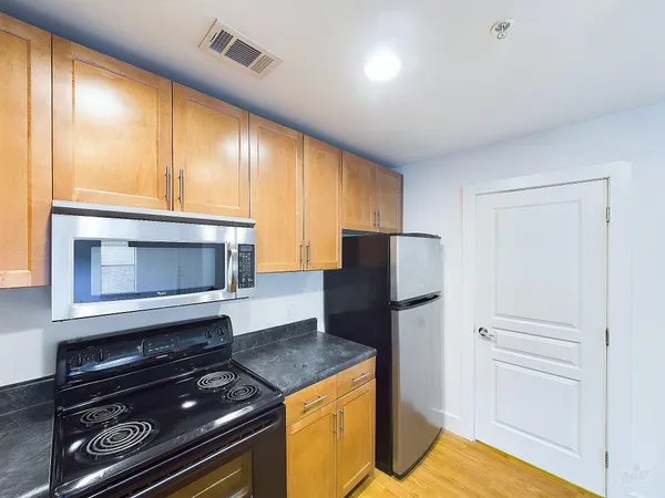 a kitchen with a refrigerator stove and microwave