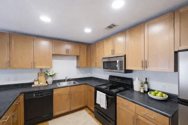 a kitchen with a sink a stove and cabinets
