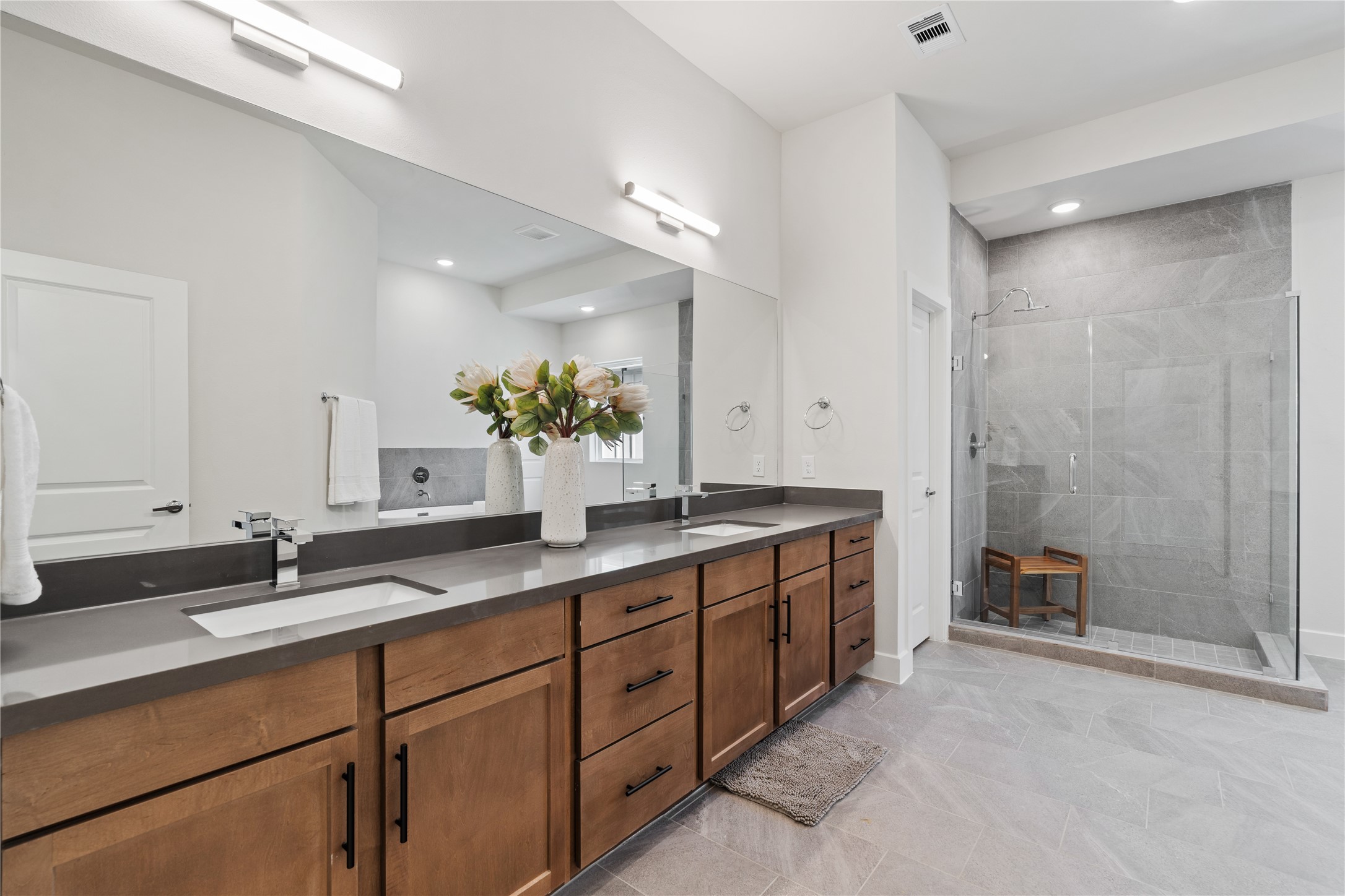 6505 Rena Street Houston, TX 77092 - Photo 17 of 28 A primary bath of this size is uncommon at this price point, with a wide double-sink vanity and glass-enclosed shower wrapped in large format tile.