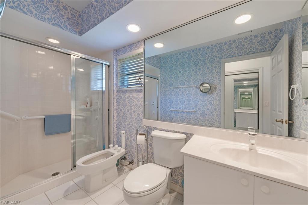 3574 Midas Place Naples, FL 34105 - Photo 16 of 29 a bathroom with a toilet a sink a mirror and shower