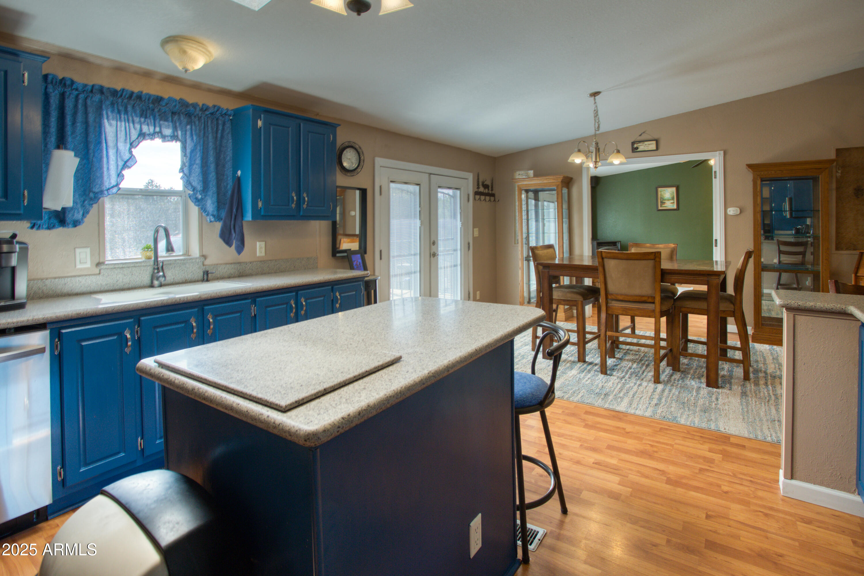 125 County Rd N3077 Show Low, AZ 85901 - Photo 13 of 71 a kitchen with stainless steel appliances granite countertop a table chairs sink and cabinets