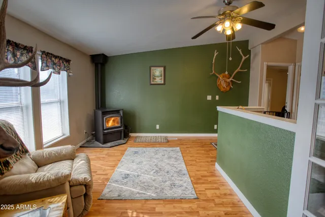 a bedroom with a bed and a flat tv screen on dresser