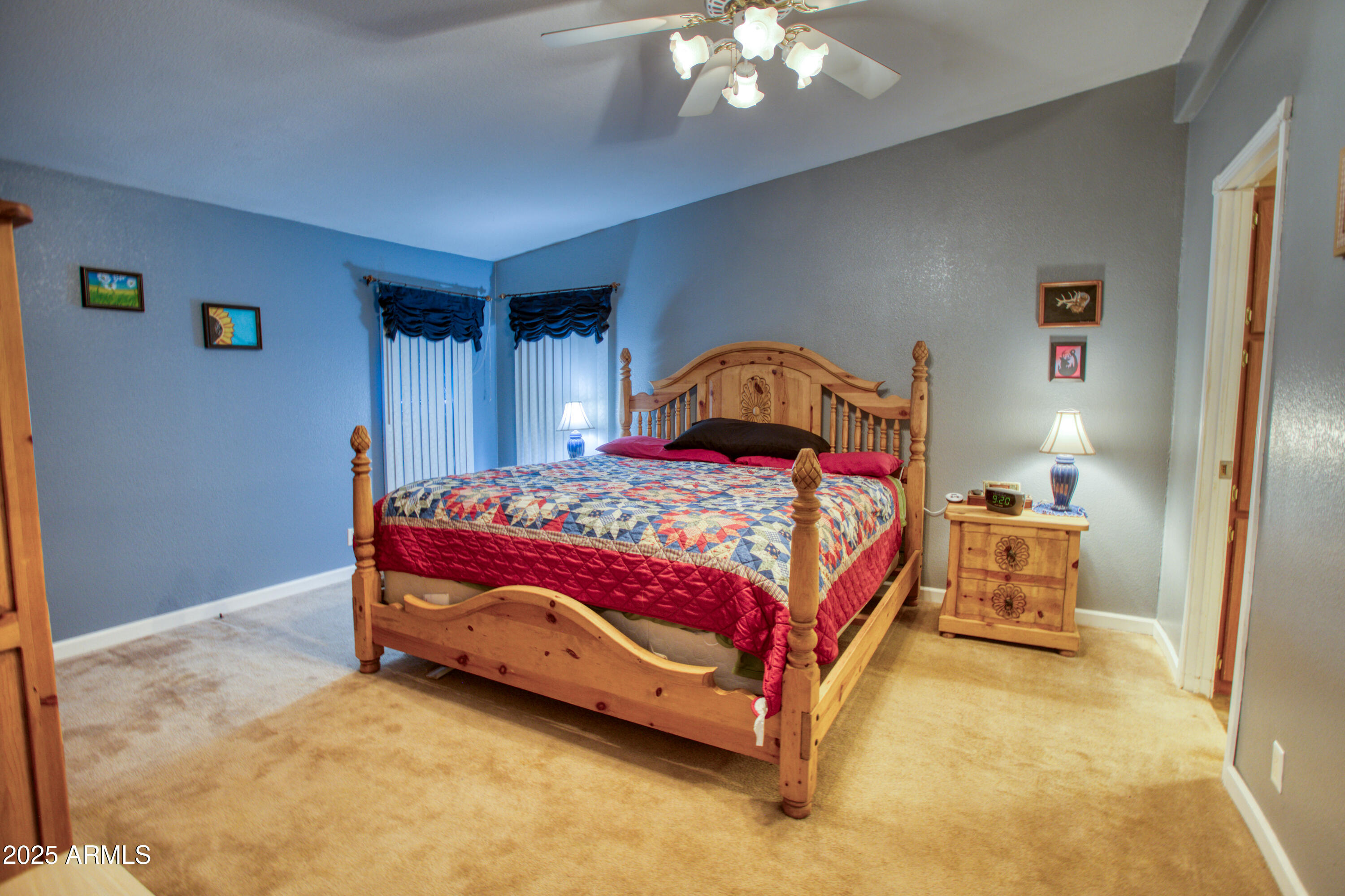 125 County Rd N3077 Show Low, AZ 85901 - Photo 18 of 71 a bedroom with a bed and a chandelier