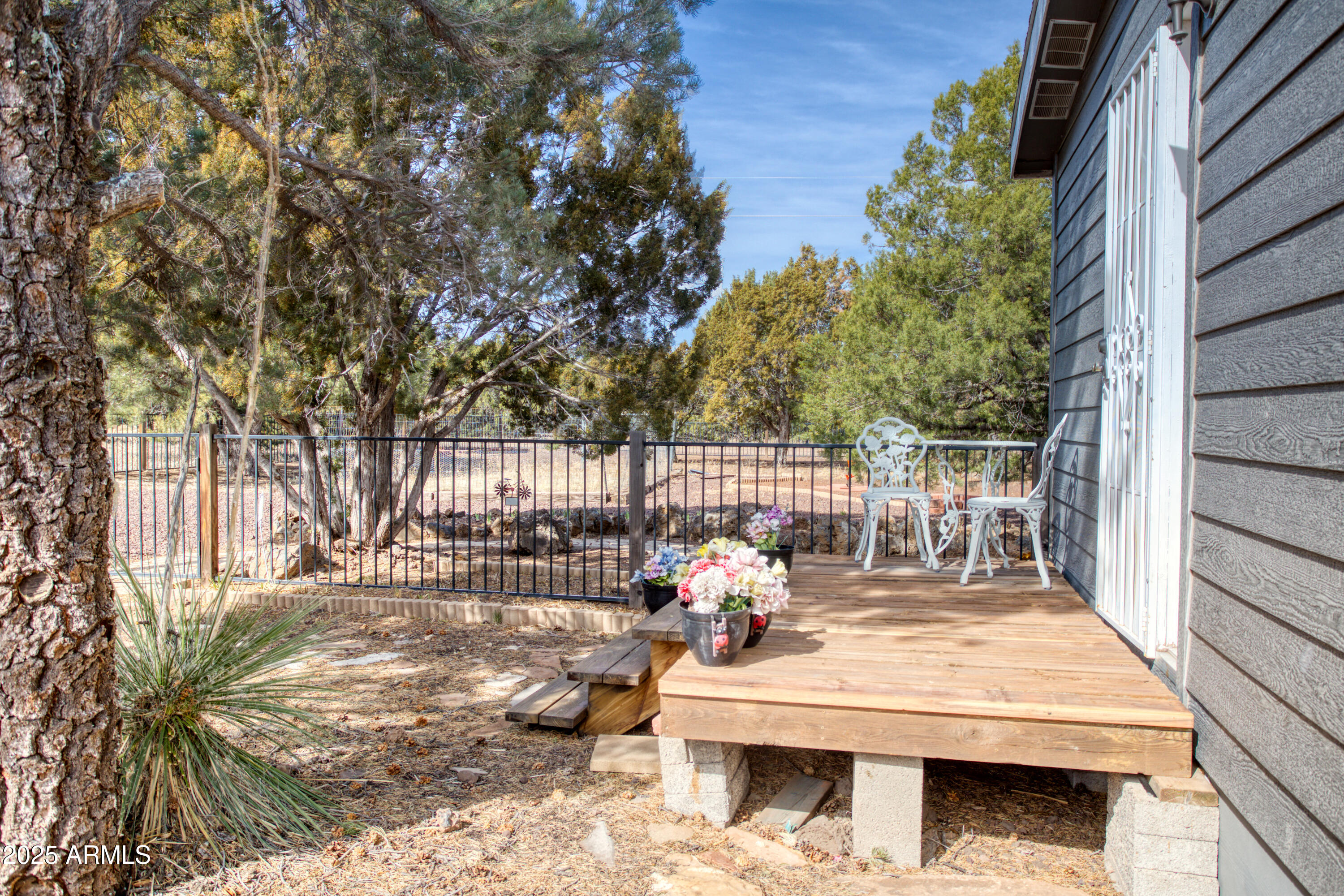 125 County Rd N3077 Show Low, AZ 85901 - Photo 31 of 71 a view of a patio with couches table and chairs and potted plants