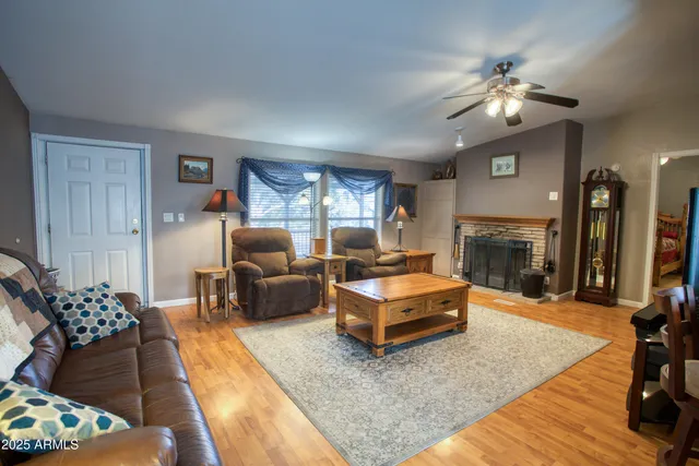 a living room with furniture fireplace and a large window