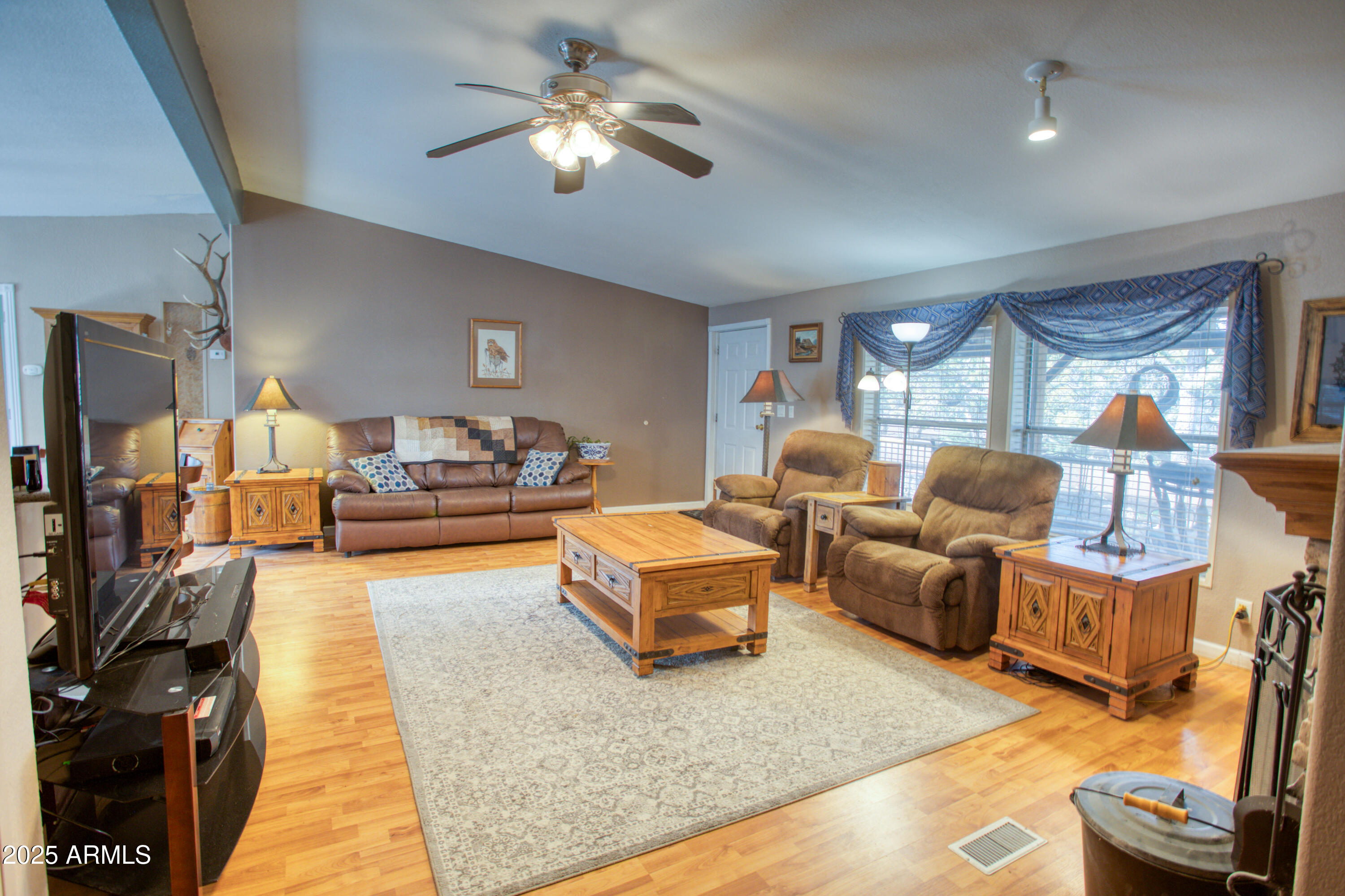 125 County Rd N3077 Show Low, AZ 85901 - Photo 4 of 71 a living room with furniture fireplace and a large window