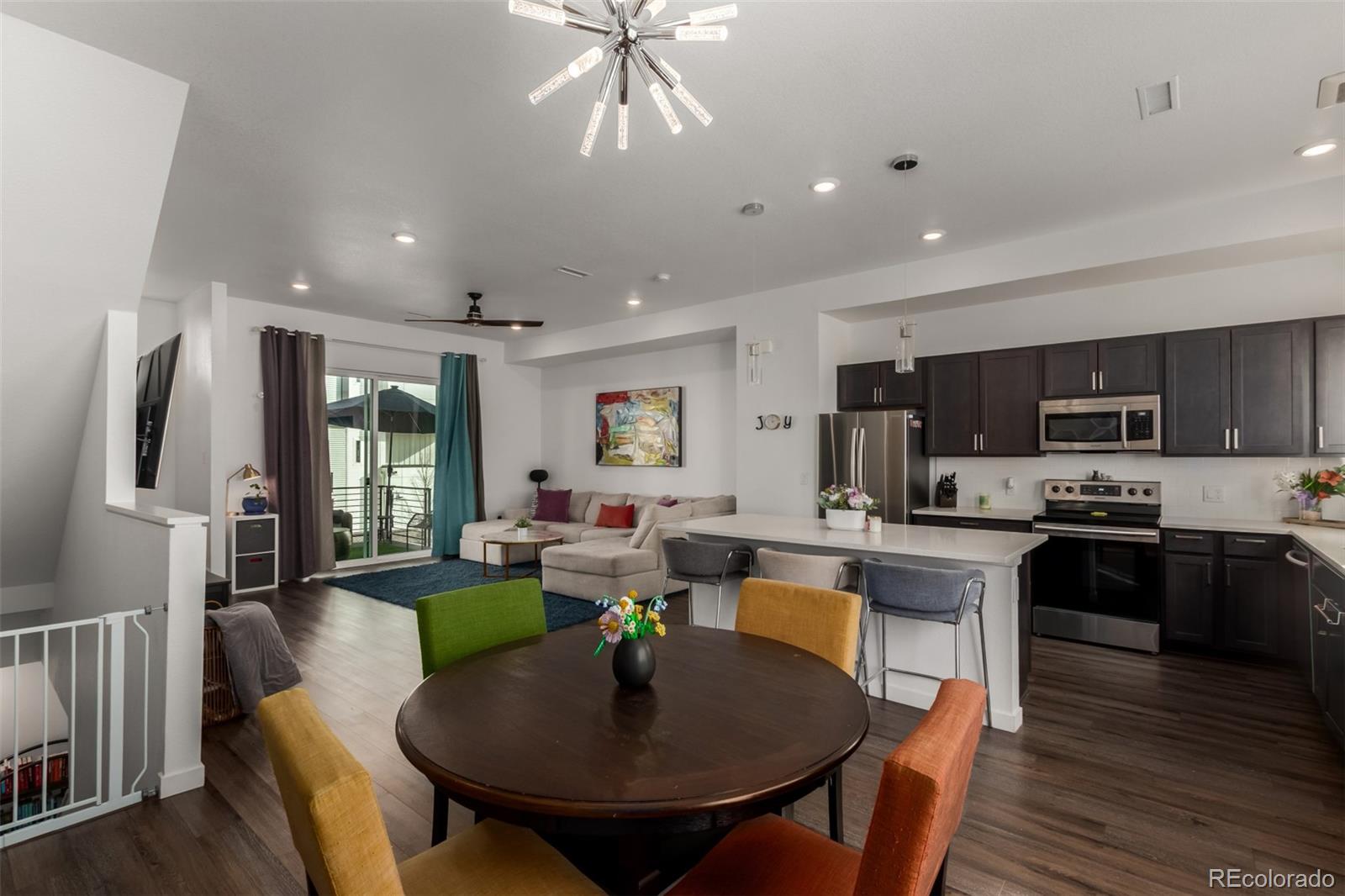 6767 Quivas Way Denver, CO 80221 - Photo 12 of 30 a large kitchen with a table and chairs