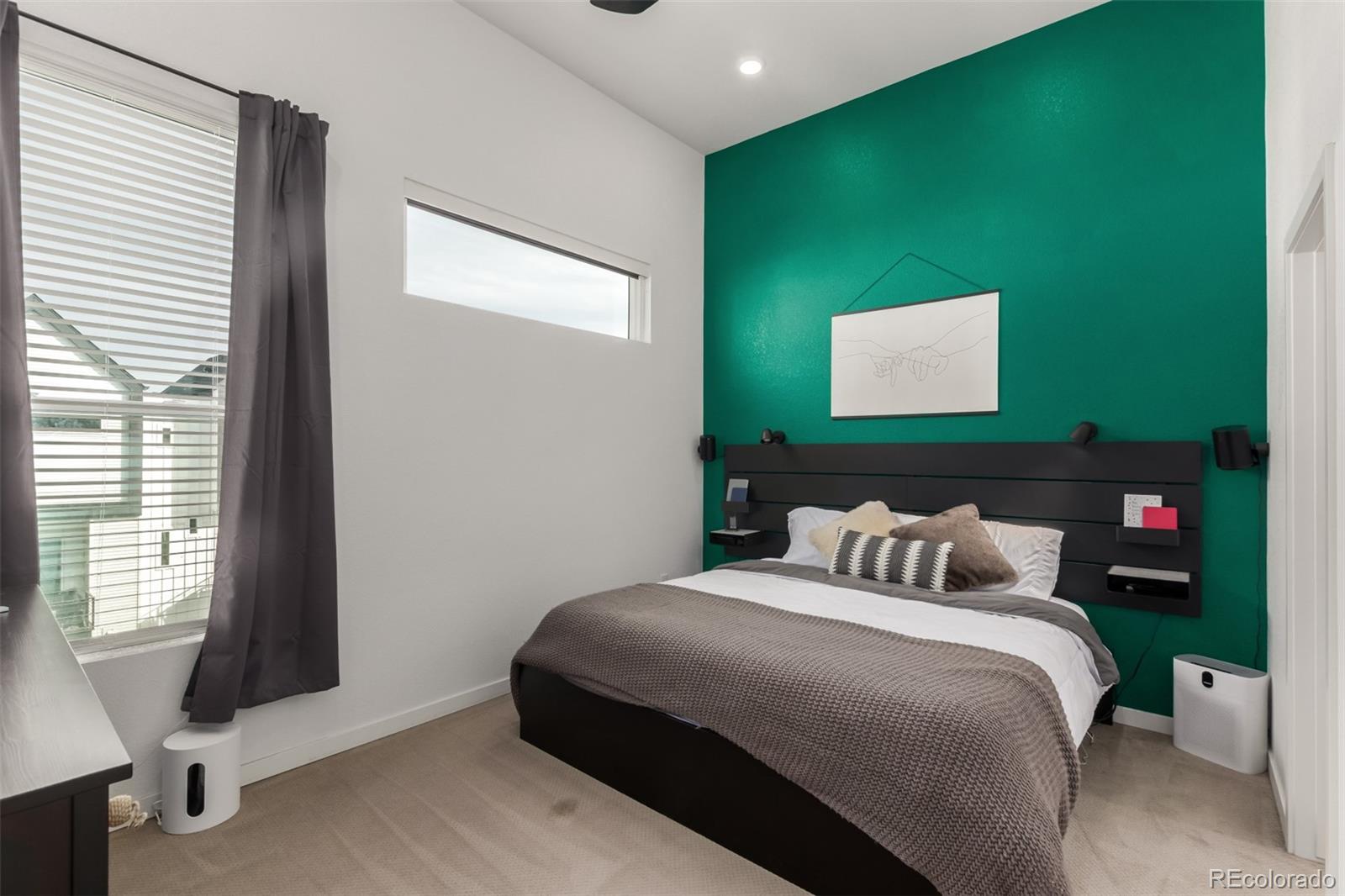 6767 Quivas Way Denver, CO 80221 - Photo 17 of 30 a bedroom with a bed and a flat screen tv