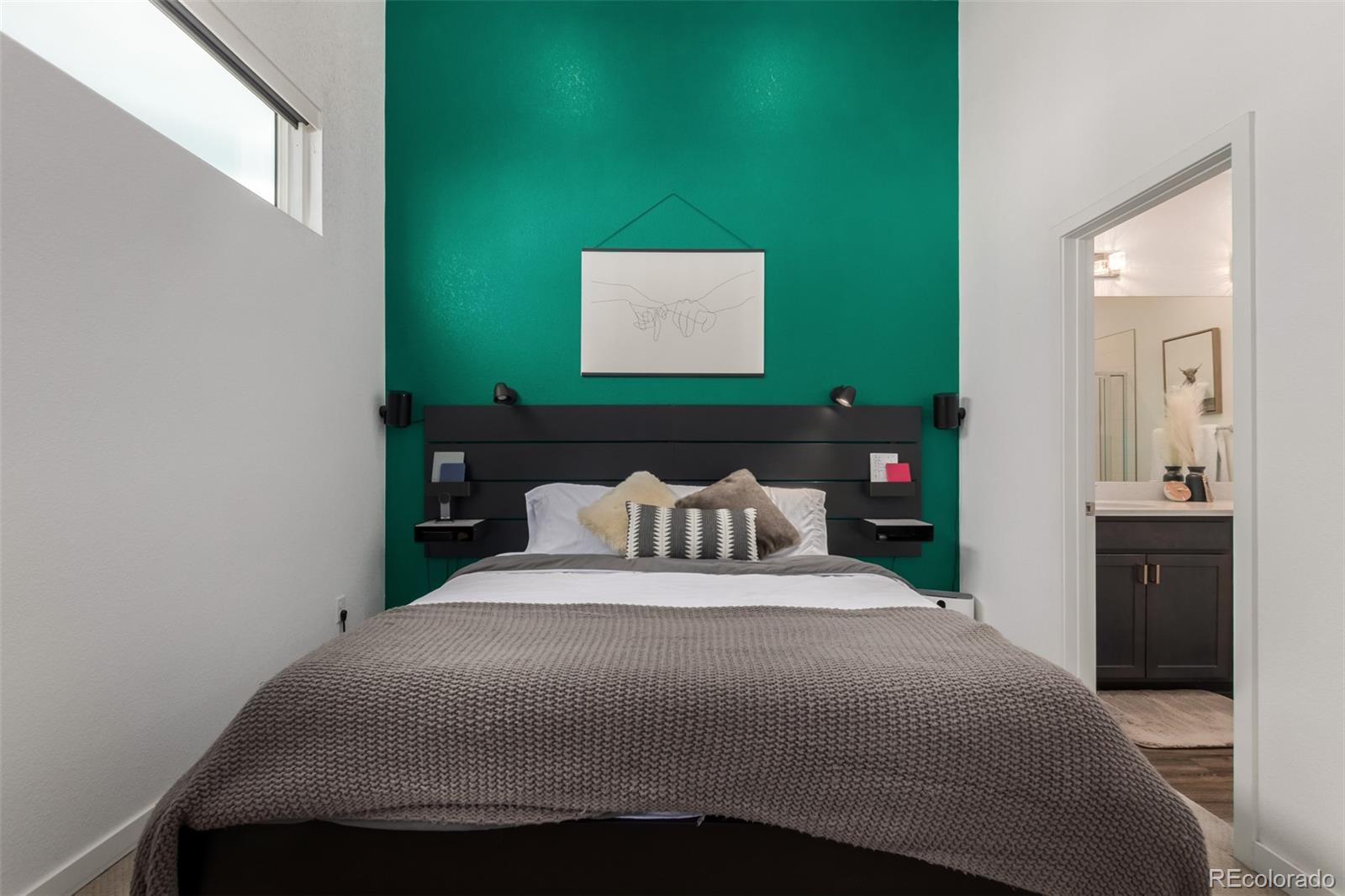 6767 Quivas Way Denver, CO 80221 - Photo 19 of 30 a bedroom with a bed and a painting on the wall