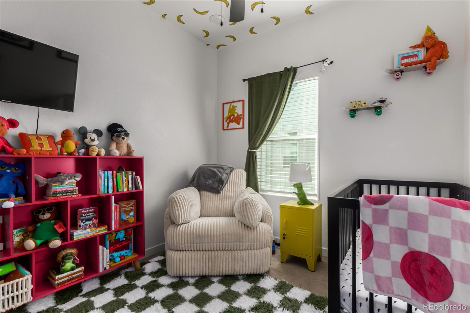 6767 Quivas Way Denver, CO 80221 - Photo 24 of 30 a bedroom with furniture and a flat screen tv