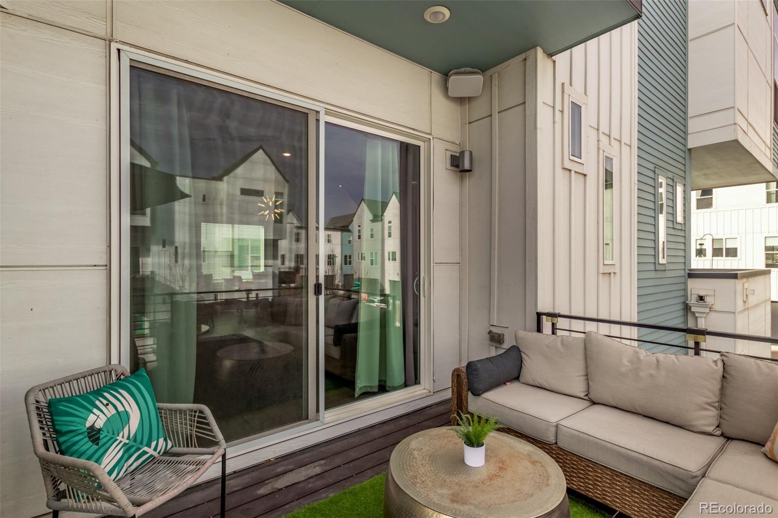6767 Quivas Way Denver, CO 80221 - Photo 30 of 30 a living room with furniture and a glass door