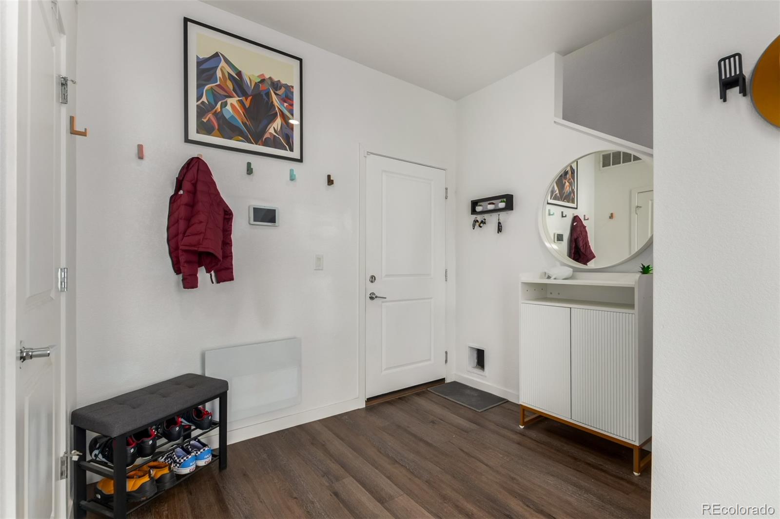 6767 Quivas Way Denver, CO 80221 - Photo 6 of 30 a view of a hallway with wooden floor and closet