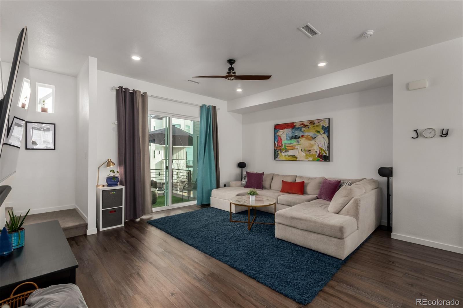 6767 Quivas Way Denver, CO 80221 - Photo 7 of 30 a living room with furniture and wooden floor