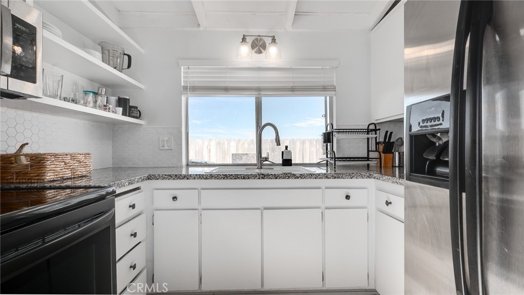 920 Raintree Place Vista, CA 92084 - Photo 11 of 18 a kitchen with stainless steel appliances granite countertop a sink and cabinets