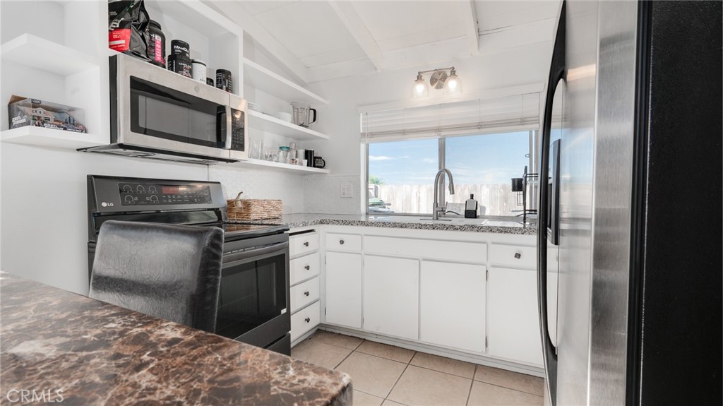920 Raintree Place Vista, CA 92084 - Photo 12 of 18 a kitchen with stainless steel appliances granite countertop a refrigerator and a stove top oven