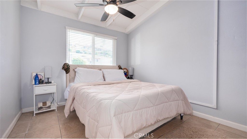920 Raintree Place Vista, CA 92084 - Photo 5 of 18 a bedroom with a bed and a chandelier