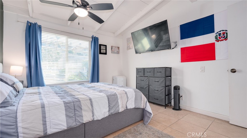 920 Raintree Place Vista, CA 92084 - Photo 6 of 18 a bedroom with a bed and a flat screen tv