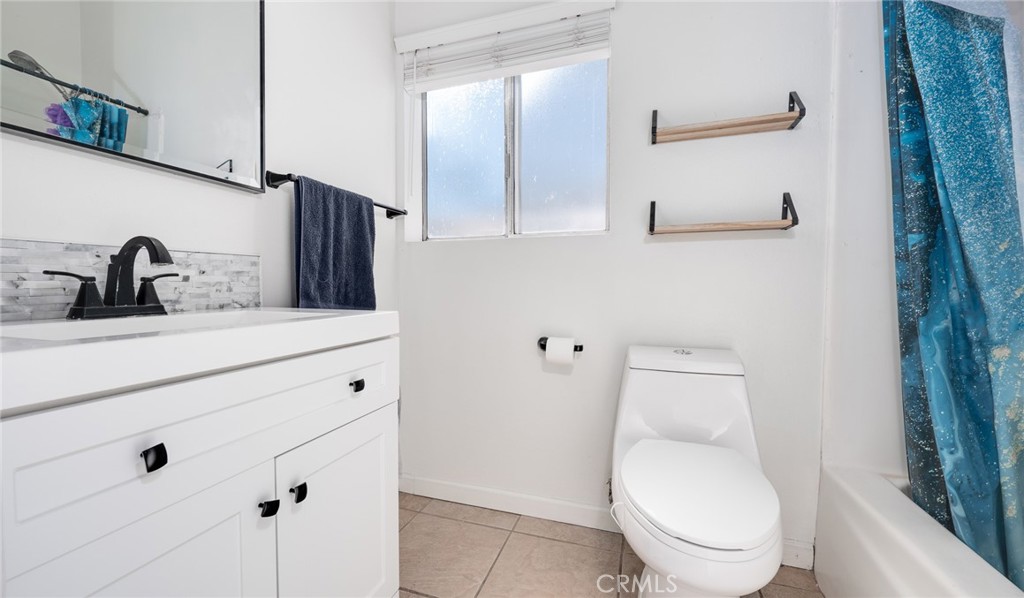 920 Raintree Place Vista, CA 92084 - Photo 9 of 18 a bathroom with a toilet sink and mirror