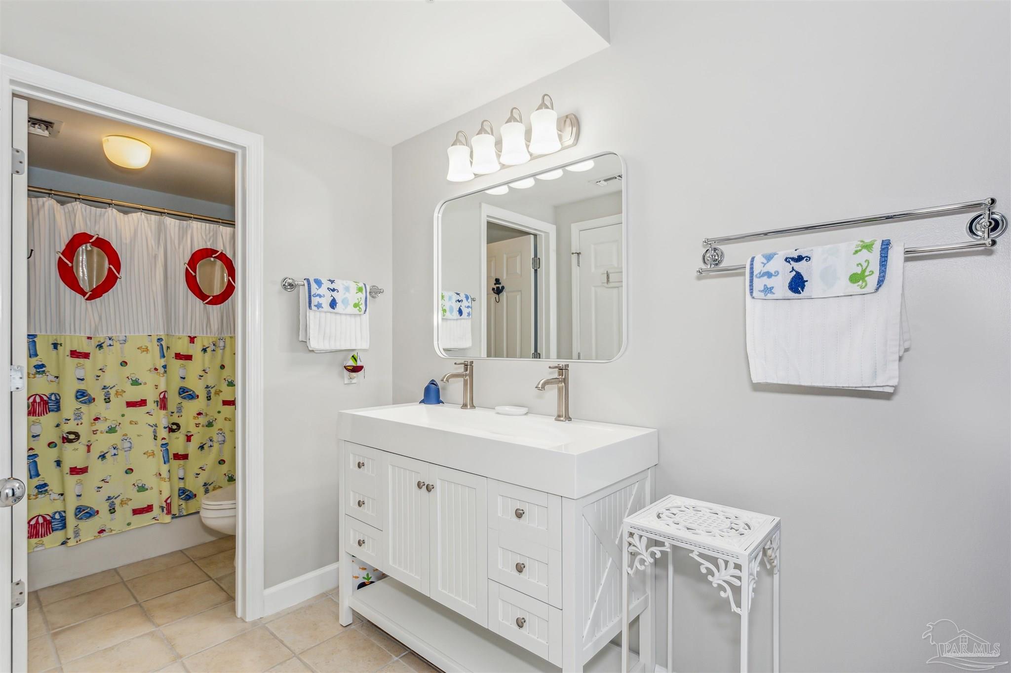 800 Fort Pickens Road, Unit 204 Pensacola Beach, FL 32561 - Photo 34 of 45 a spacious bathroom with a sink a mirror and a shower