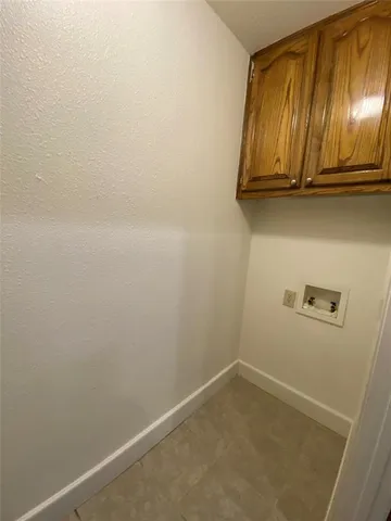 a view of an empty room with a chandelier fan