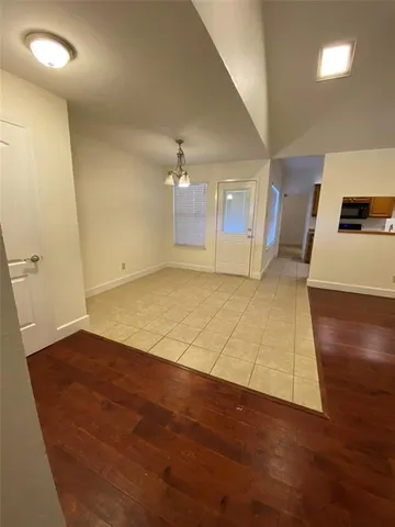 a view of a livingroom with a fireplace a ceiling fan and wooden floor