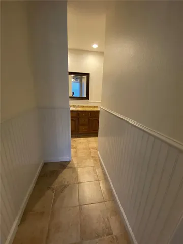 a bathroom with a sink a large mirror and a bathtub