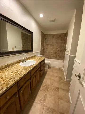 a kitchen with stainless steel appliances granite countertop a sink and a stove