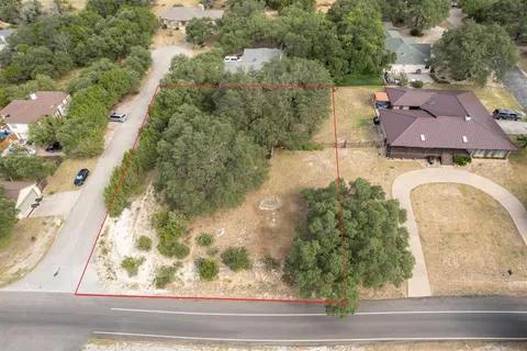 an aerial view of a house with a yard and lake view